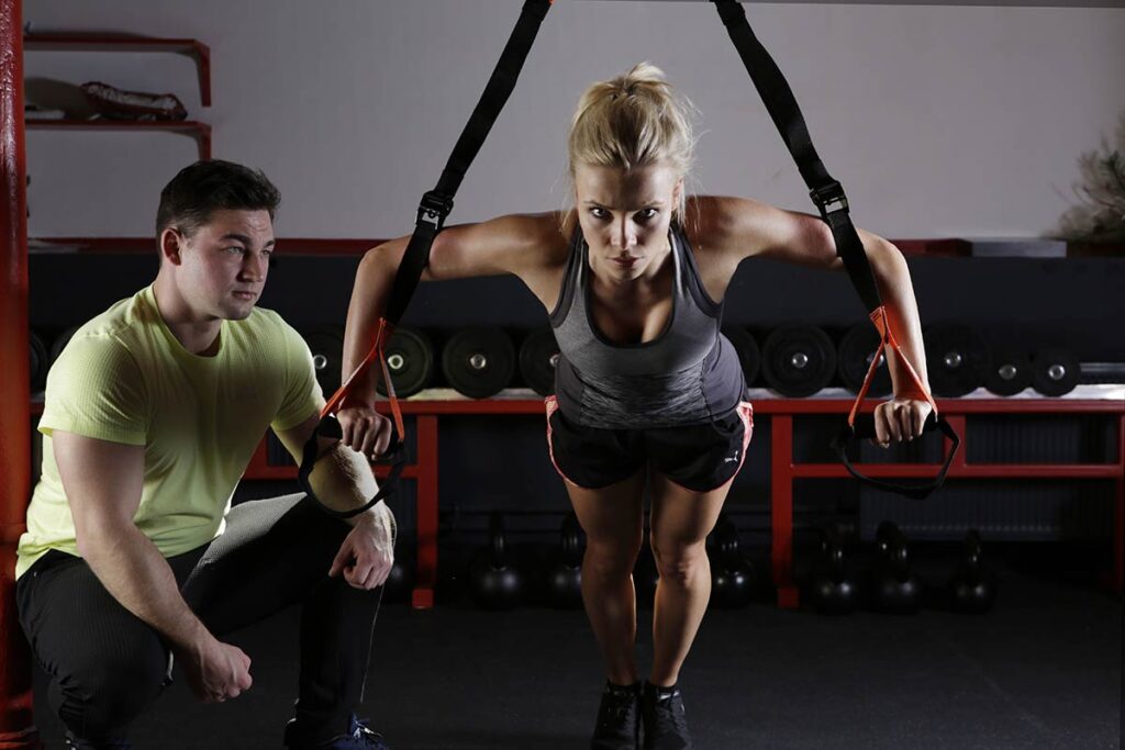 Woman and her trainer in a gym