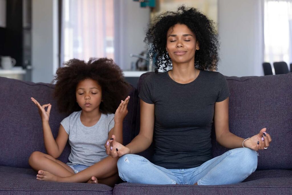 Mother and daughter meditating